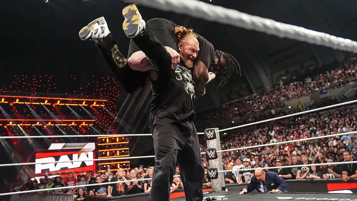 Brock Lesnar wrestling Oba Femi in a wrestling ring at Boardwalk Hall Arena
