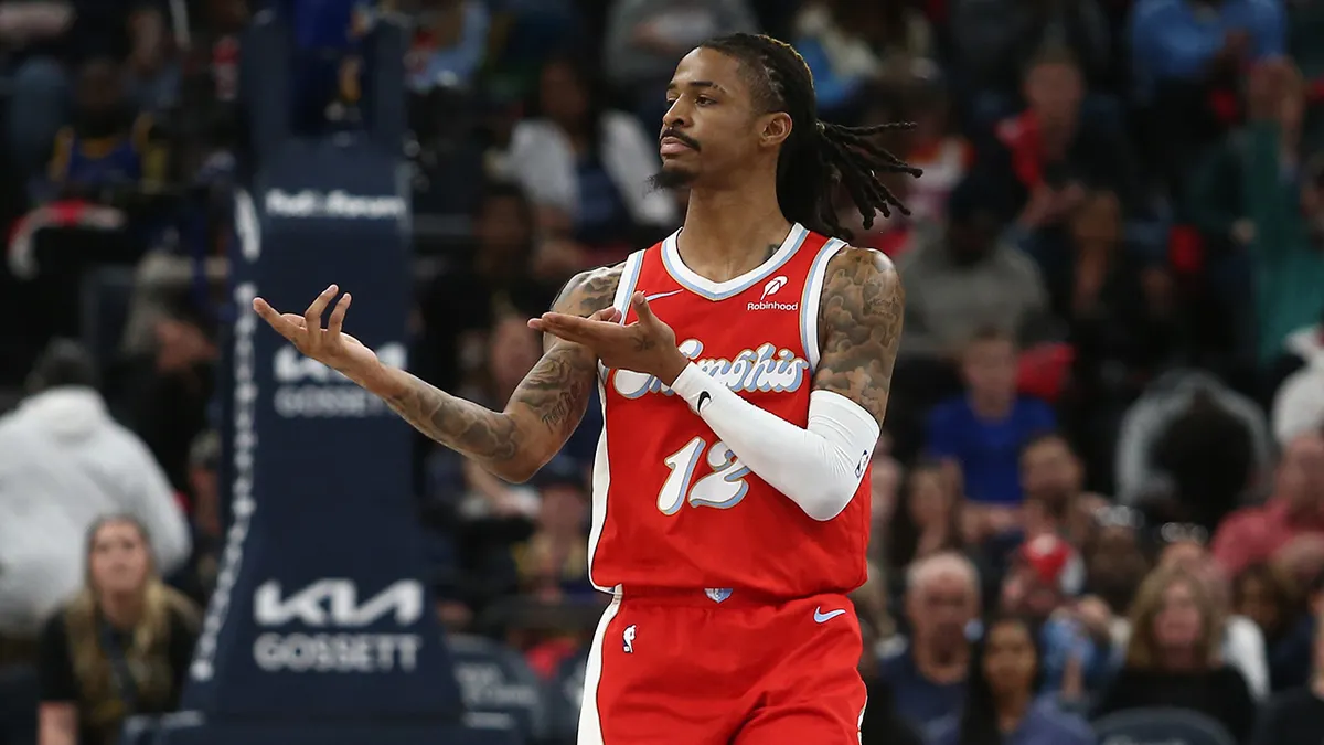 Ja Morant points during a game